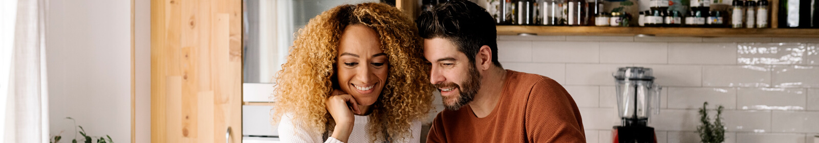 Young couple in kitchen.