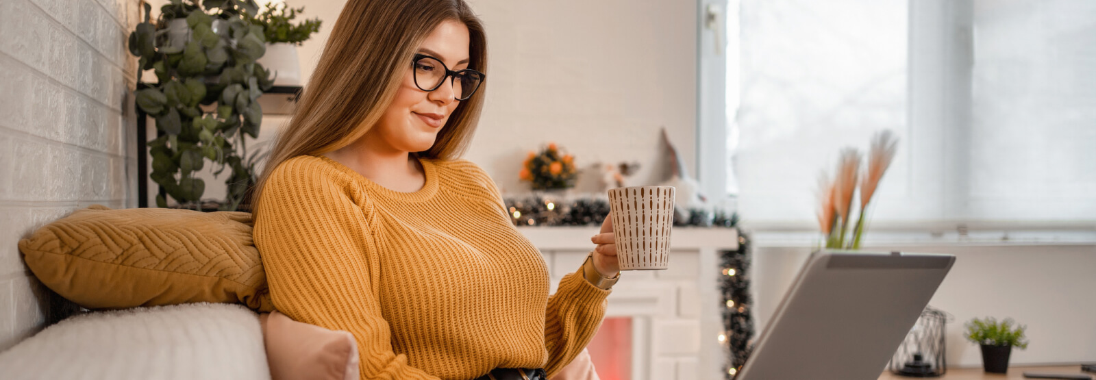 Woman with coffee on her computer.